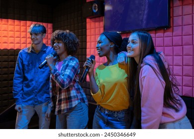 Diverse multiethnic teenage friends singing at karaoke - Powered by Shutterstock