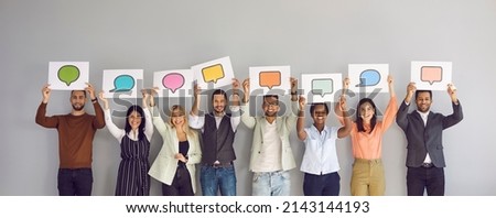 Diverse multiracial multiethnic people show various paper sheets and cards with pictures of different colorful mockup messenger and social media chat icons and message bubbles. Communication concept
