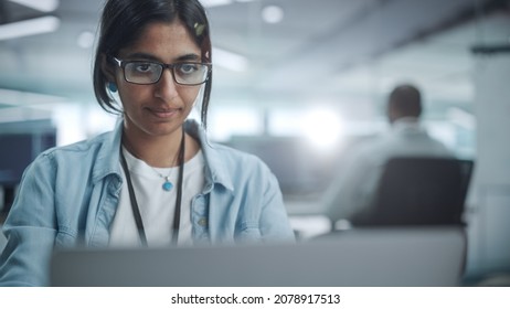 Diverse Office: Portrait Of Beautiful Indian IT Programmer Working On Desktop Computer. Empowered Female Software Engineer Creating Innovative App, Program, Video Game In Friendly Environment