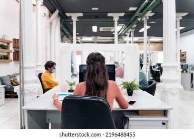 Diverse Office Workers Sitting In A Big Desk And Working With Laptops. Co-working Concept.