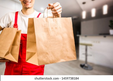 Diverse of paper containers for takeaway food. Delivery man is carrying - Shutterstock ID 1459738184