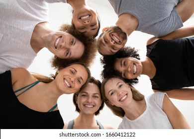 Diverse people in activewear standing in circle look at camera, girls guys at yoga class showing team spirit unity, ready to start workout at fitness studio motivated by good teamwork result concept - Powered by Shutterstock