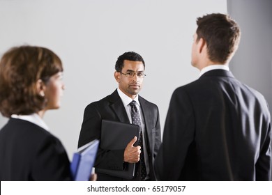 Diverse People In Business Suits, Standing Together In Serious Mood, Focus On Man Wearing Eyeglasses