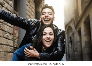 Diverse people celebrating at camera together in city street - Transgender person laughing with friend outside - Youth community concept - Powered by Shutterstock