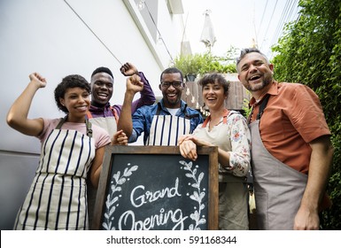 Diverse People With Grand Opening Sign First Day Of Business