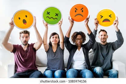 Diverse people holding emoticon - Shutterstock ID 1085974136