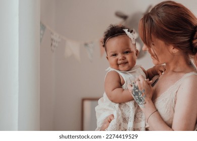 Diverse people portrait of mother with swarthy infant spending time in snugly apartment. Multi ethnic family having fun togetherness enjoying motherhood positive emotion motherly care at home - Powered by Shutterstock