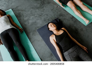 Diverse People In A Savasana Pose