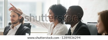 Diverse people sitting at boardroom, african woman raise hand ask question during seminar conference, corporate education or volunteer voting concept. Horizontal photo banner for website header design
