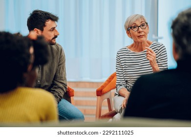 Diverse people talking on group therapy meeting and discussing addiction and mental health problems. Patients talking about their mental health issues and looking for support. Copy space. - Powered by Shutterstock