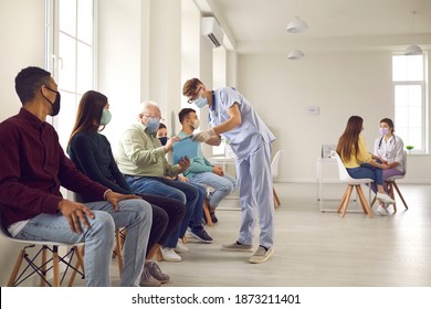 Diverse People Waiting In Line To Get Shots Or To Get Tested For Covid-19 Infection At The Hospital. Senior Patient Signing Informed Consent For Vaccination Against Pneumonia, Influenza Or Coronavirus