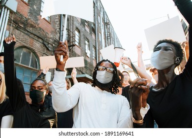 Diverse people wearing mask protesting during COVID-19 pandemic - Powered by Shutterstock