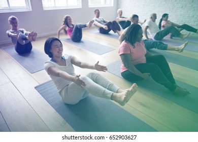 Diverse People In A Yoga Class Doing Balancing Position