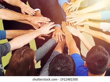 Diverse people's hands gathered together, friends all over the world