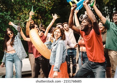 Diverse And Playful Group Of Young People Dancing And Socializing Together At Daytime Garden Party - Multigenerational Joyful Family Enjoying Their Holidays Outdoors - Focus On African Man