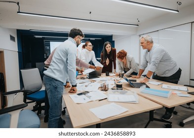 Diverse professionals attend a business lecture, collaborate, and brainstorm in a classroom. They discuss stats, share ideas, and improve their skills for successful teamwork and profit growth. - Powered by Shutterstock