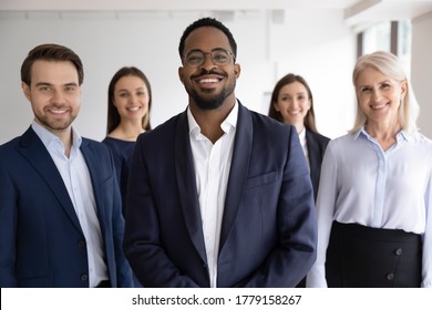 Diverse Professionals Bank Employees Company Staff Members In Formal Wear, 5 Businesspeople Lead By African Ethnicity Leader Posing Standing Together In Office. Young Aged Specialists Portrait Concept