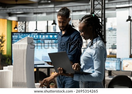 Diverse real estate developers study architectural 3D models for city planning and zoning regulations, ensuring infrastructure growth for sustainable residential project master plan.