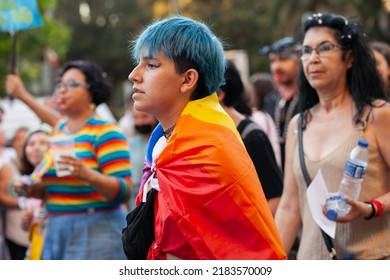 Diverse Real People With Colored Hair Walking At Pride Parade With Rainbow Flag As Symbol Of Pride Month. Queer Community March In The Street With Crowds.  VALENCIA, SPAIN - JUNE 25 2022