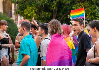 Diverse Real People Walking At Pride Parade With Rainbow Flag As Symbol Of Pride Month. Queer Community March In The Street With Crowds. LGBTQIA March, Inclusivity: VALENCIA, SPAIN - JUNE 25 2022