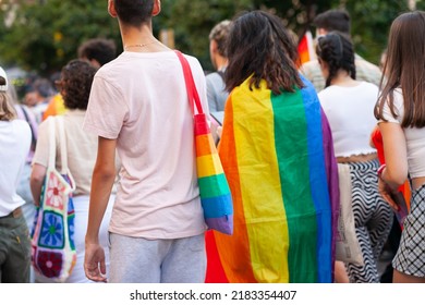 Diverse Real People Walking At Pride Parade With Rainbow Flag As Symbol Of Pride Month. Queer Community March In The Street With Crowds. LGBTQIA March, Inclusivity: VALENCIA, SPAIN - JUNE 25 2022