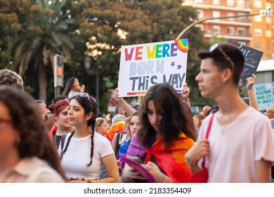 Diverse Real People Walking At Pride Parade With Rainbow Flag As Symbol Of Pride Month. Queer Community March In The Street With Crowds. LGBTQIA March, Inclusivity: VALENCIA, SPAIN - JUNE 25 2022