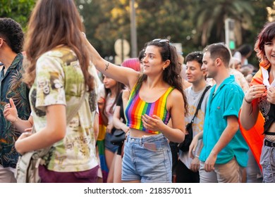 Diverse Real People Walking At Pride Parade With Rainbow Flag As Symbol Of Pride Month. Queer Community March In The Street With Crowds. LGBTQIA March, Inclusivity: VALENCIA, SPAIN - JUNE 25 2022