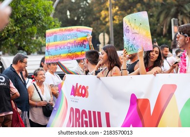 Diverse Real People Walking At Pride Parade With Rainbow Flag As Symbol Of Pride Month. Queer Community March In The Street With Crowds. LGBTQIA March, Inclusivity: VALENCIA, SPAIN - JUNE 25 2022