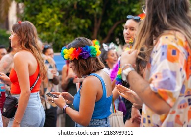 Diverse Real People Walking At Pride Parade With Rainbow Flag As Symbol Of Pride Month. Queer Community March In The Street With Crowds. LGBTQIA March, Inclusivity: VALENCIA, SPAIN - JUNE 25 2022