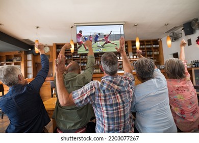 Diverse Senior Friends In Bar Watching Tv With Football Match On Screen. Global Sport Concept, Digital Composite Image.