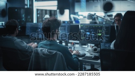 Diverse Software Development Department Working in a Cyber Security Artificial Intelligence Company. Web Engineers Working on a Desktop Computers. Shot from the Back
