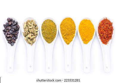 Diverse of spices in ceramic spoon isolated on white background - Powered by Shutterstock