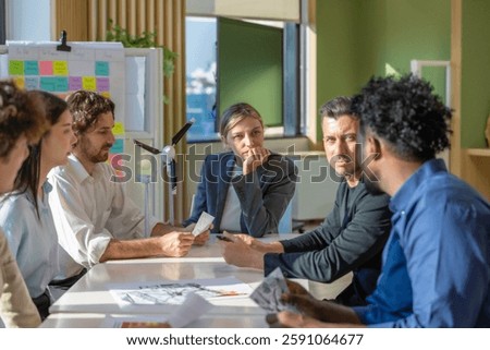 A diverse startup team develop, collaborates on a powerful, lightweight, portable wind turbine prototype, aligning with potential user demand and renewable energy needs to secure investor funding.