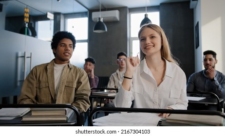 Diverse Students Classmates Attentively Listening To Interesting Lecture Enthusiasm In Classroom Young Caucasian Girl Raising Hand Knows Answer Answers Question Higher Education Concept In College