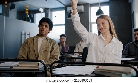 Diverse Students Classmates Attentively Listening To Interesting Lecture Enthusiasm In Classroom Young Caucasian Girl Raising Hand Knows Answer Answers Question Higher Education Concept In College
