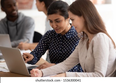 Diverse students take part in shared task solving using pc educational website learn online search information, indian ethnicity girl show to mate info in internet, partnership teamwork study concept