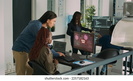 Diverse team of app developers having computer hacked and writing code, encountering unexpected system error in software development office. Coders having server failure while creating algorithm.