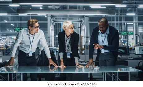 Diverse Team of Automotive Engineers Working in Office at Car Factory. Industrial Designers Talk and Discuss Invisible Object Made in Augmented Reality. Great Template for Your AR Objects - Powered by Shutterstock