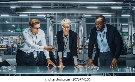 Diverse Team of Automotive Engineers Working in Office at Car Factory. Industrial Designers Talk and Make Gestures of Moving Invisible Object in Augmented Reality. Great Template for Your AR Objects - Shutterstock ID 2076774250