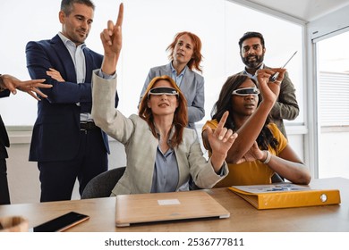 Diverse team of business professionals is wearing vr glasses and interacting with virtual reality during a meeting in the office - Powered by Shutterstock