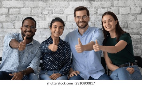 Diverse team of candidates successfully passed job interview, happy about hiring, showing thumb up like gesture. Applicants or customers satisfied with work condition, high quality service in company - Powered by Shutterstock