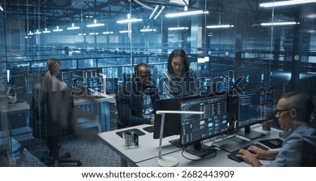 Diverse Team of Developers Working on Computers in a Modern Office in a Data Center Facility. Team Analyzing Data and Optimizing Systems. Asian Manager Having a Conversation with a Colleague
