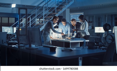 Diverse Team of Electronics Development Engineers Standing at the Desk with 3D Printer and PCB Motherboards. Specialists Working on Ultra Modern Industrial Design, Using Advanced Technology - Powered by Shutterstock