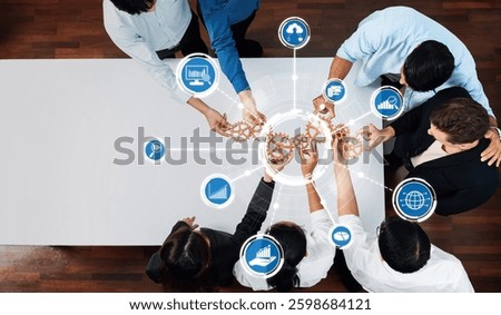A diverse team engages in collaborative strategy-building session, using visuals and analytics to enhance communication and productivity in a professional setting. Amity
