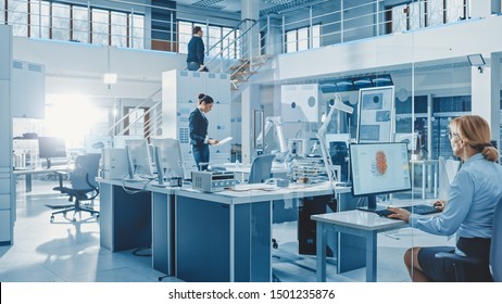 Diverse Team of Engineers Working on Computers, Program and Manipulate Robot Arm, Discuss Problems in Bright Industrial Robotics Technology and Design Office. Working in Research Facility. - Shutterstock ID 1501235876