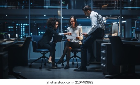 Diverse Team of Managers Working and Having Discussions in Big City Office in the Evening. Colleagues Talk, Discuss Business Opportunities, Evaluate Financial Reports, Plan Investment Strategy.