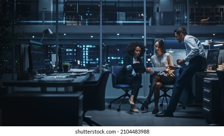 Diverse Team of Managers Working and Having Discussions in Big City Office in the Evening. Colleagues Talk, Discuss Business Opportunities, Evaluate Financial Reports, Plan Investment Strategy.