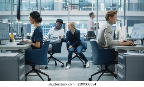 Diverse Team of Managers Working and Having Discussions in Modern Big City Office. Colleagues Work on New Business Opportunities, Evaluate Financial Reports, Plan Investment Strategy.