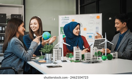 Diverse team, middle-aged Asian businessman, Caucasian young businesswoman, Muslim hijab-wearing businesswoman, meets in boardroom to discuss a wind turbine project for sustainable energy solutions. - Powered by Shutterstock