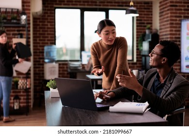 Diverse Team Of People Working On Laptop In Disability Friendly Office, Man With Physical Health Condition At Work. Company Worker With Impairment Brainstorming Ideas With Woman.